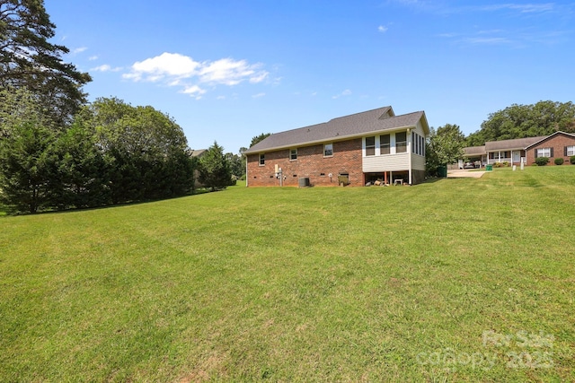 416 Park Ave, Granite Quarry, NC 28072 - back of house with a yard and brick siding
