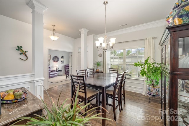 7718 Village Pkwy, Locust, NC 28097 - dining area featuring ornate columns, a chandelier, wood finished floors, crown molding, and wainscoting