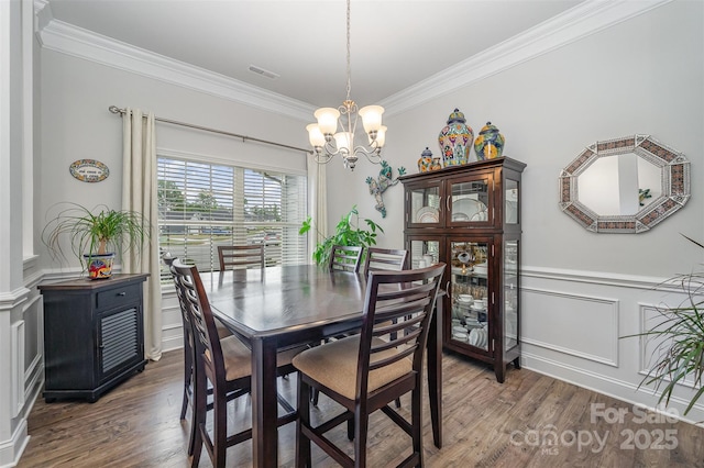 7718 Village Pkwy, Locust, NC 28097 - dining area with a chandelier, ornamental molding, wood finished floors, a wainscoted wall, and a decorative wall