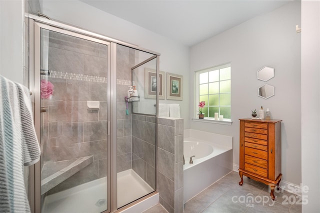 7718 Village Pkwy, Locust, NC 28097 - full bathroom with a bath, a stall shower, and tile patterned flooring