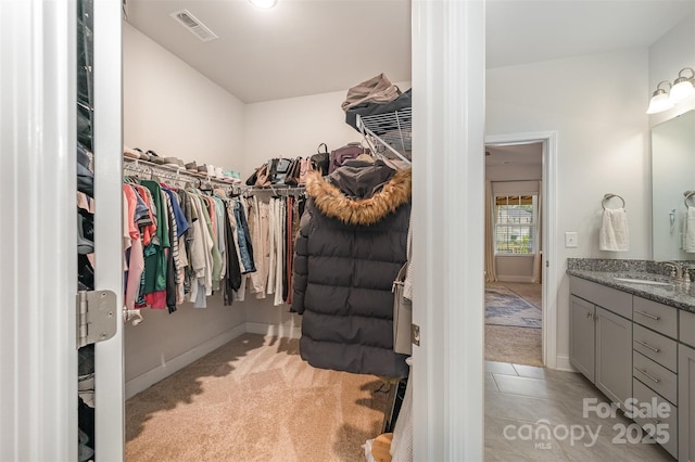7718 Village Pkwy, Locust, NC 28097 - walk in closet featuring light colored carpet and light tile patterned flooring