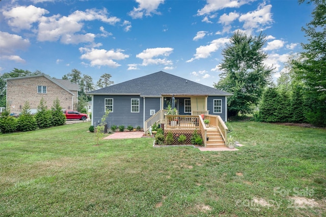 7718 Village Pkwy, Locust, NC 28097 - view of front facade with a front lawn, a wooden deck, and roof with shingles