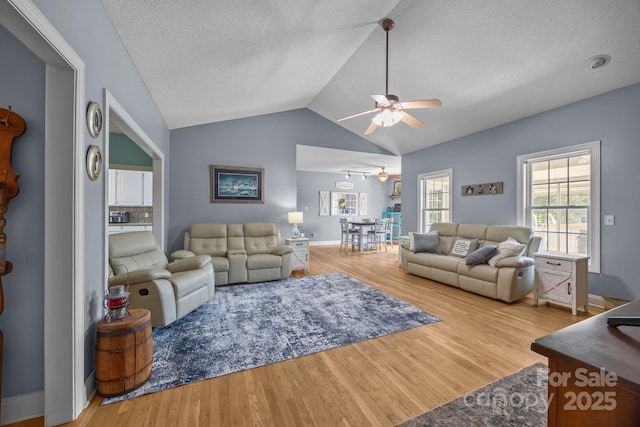 315 Talon Dr, Salisbury, NC 28147 - living room featuring a ceiling fan, wood finished floors, vaulted ceiling, and a textured ceiling