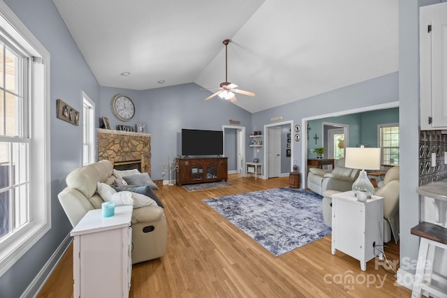 315 Talon Dr, Salisbury, NC 28147 - living room with ceiling fan, light wood-style flooring, vaulted ceiling, and a fireplace