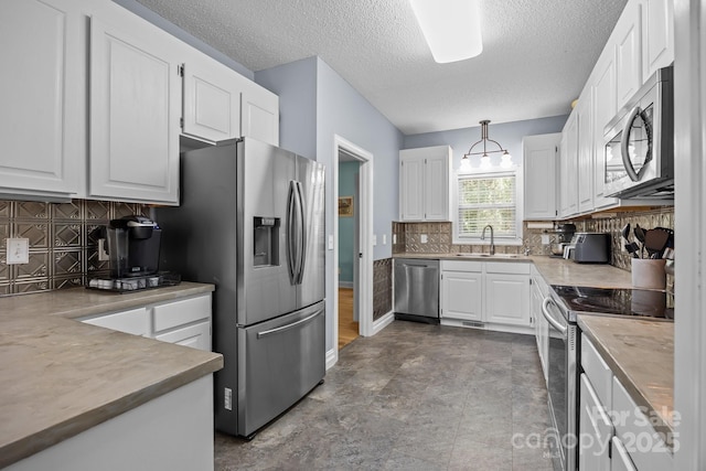 315 Talon Dr, Salisbury, NC 28147 - kitchen with appliances with stainless steel finishes, white cabinetry, decorative backsplash, pendant lighting, and a textured ceiling