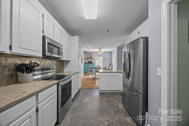 315 Talon Dr, Salisbury, NC 28147 - kitchen with appliances with stainless steel finishes, a textured ceiling, white cabinetry, ceiling fan, and light countertops