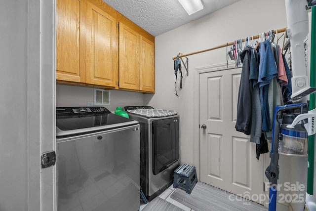 315 Talon Dr, Salisbury, NC 28147 - laundry room featuring cabinet space, washing machine and dryer, a textured ceiling, and light tile patterned floors