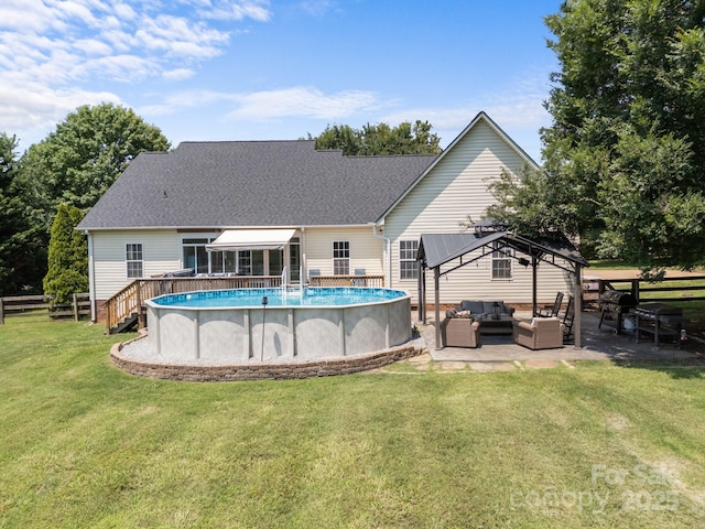 315 Talon Dr, Salisbury, NC 28147 - rear view of house with outdoor lounge area, a gazebo, an outdoor pool, roof with shingles, and a sunroom