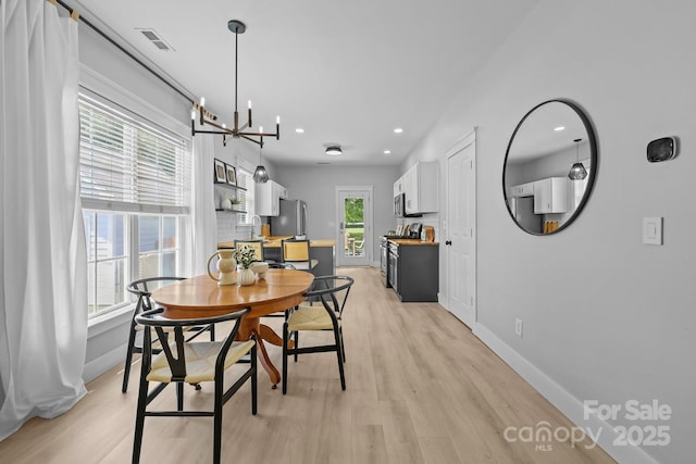 8225 Ballymore Ct, Huntersville, NC 28078 - dining space featuring light wood-style flooring, a chandelier, and recessed lighting