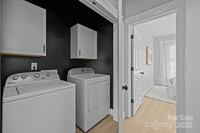 8225 Ballymore Ct, Huntersville, NC 28078 - laundry area featuring cabinet space, separate washer and dryer, and light wood-style flooring