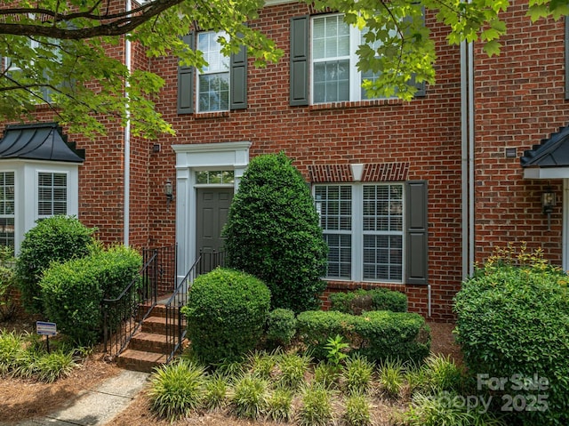 734 Naramore St, Davidson, NC 28036 - view of exterior entry featuring brick siding