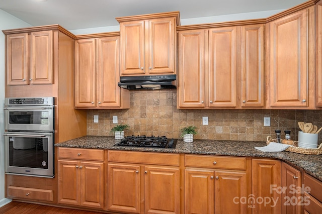 734 Naramore St, Davidson, NC 28036 - kitchen featuring black gas stovetop, double oven, under cabinet range hood, dark stone countertops, and backsplash