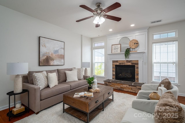 734 Naramore St, Davidson, NC 28036 - living area with wood finished floors, a ceiling fan, a stone fireplace, and recessed lighting