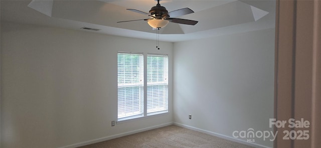 162 Autumn Falls Dr, Lake Wylie, SC 29710 - spare room with light colored carpet, a ceiling fan, and a tray ceiling