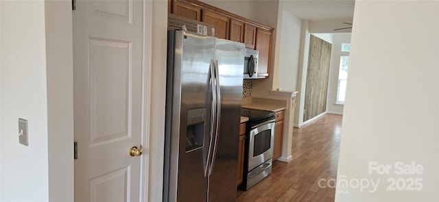 162 Autumn Falls Dr, Lake Wylie, SC 29710 - kitchen featuring appliances with stainless steel finishes, brown cabinetry, light wood-type flooring, and light countertops
