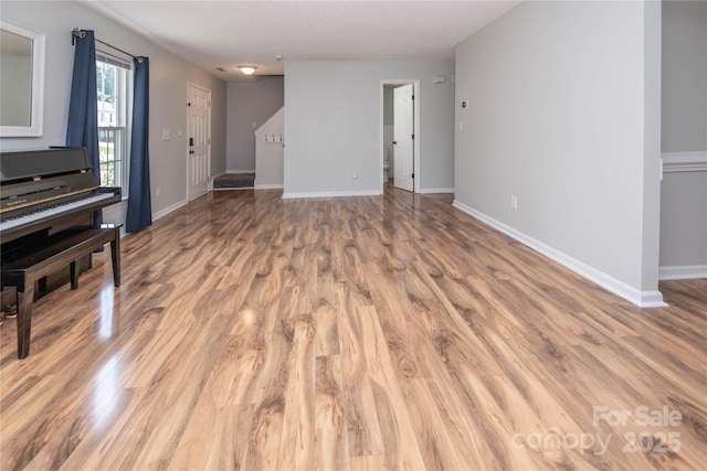 2085 Chapel Creek Rd SW, Concord, NC 28025 - unfurnished living room featuring light wood-type flooring and baseboards