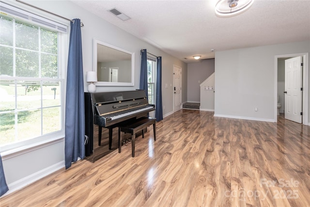 2085 Chapel Creek Rd SW, Concord, NC 28025 - sitting room featuring light wood-style flooring, a textured ceiling, and healthy amount of natural light