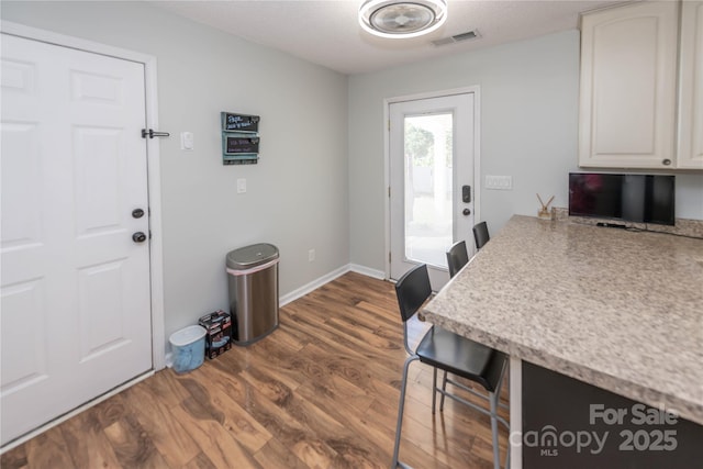 2085 Chapel Creek Rd SW, Concord, NC 28025 - kitchen with light countertops, dark wood-style floors, and white cabinets