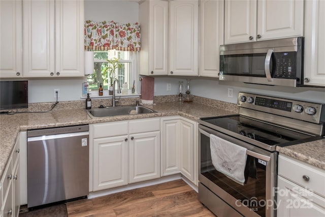 2085 Chapel Creek Rd SW, Concord, NC 28025 - kitchen featuring stainless steel appliances, white cabinets, and wood finished floors