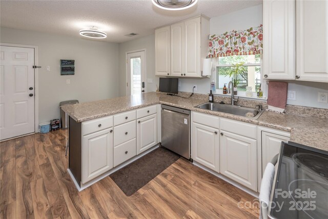 2085 Chapel Creek Rd SW, Concord, NC 28025 - kitchen featuring dishwasher, range with electric stovetop, a peninsula, white cabinetry, and dark wood finished floors