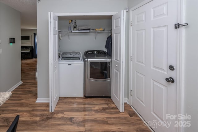 2085 Chapel Creek Rd SW, Concord, NC 28025 - washroom featuring washer and clothes dryer and wood finished floors