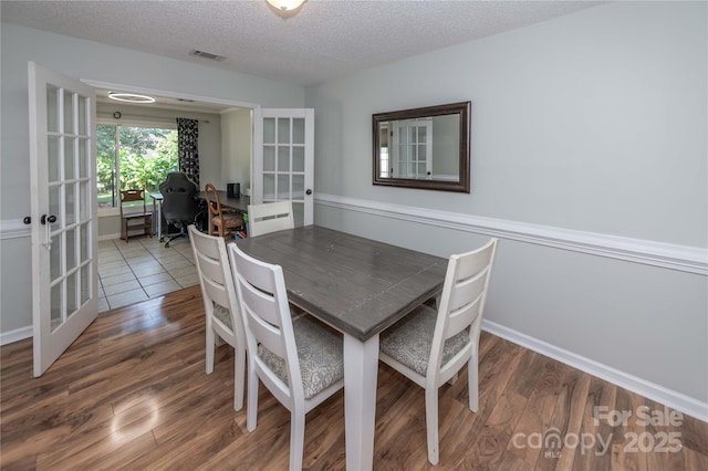 2085 Chapel Creek Rd SW, Concord, NC 28025 - dining room with french doors, wood finished floors, a textured ceiling, and an office area