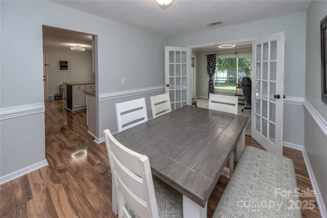 2085 Chapel Creek Rd SW, Concord, NC 28025 - dining space featuring french doors, dark wood-type flooring, and a textured ceiling