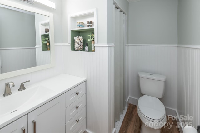 2085 Chapel Creek Rd SW, Concord, NC 28025 - bathroom with wainscoting, vanity, and wood finished floors