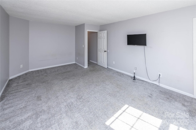 2085 Chapel Creek Rd SW, Concord, NC 28025 - carpeted spare room with baseboards and a textured ceiling