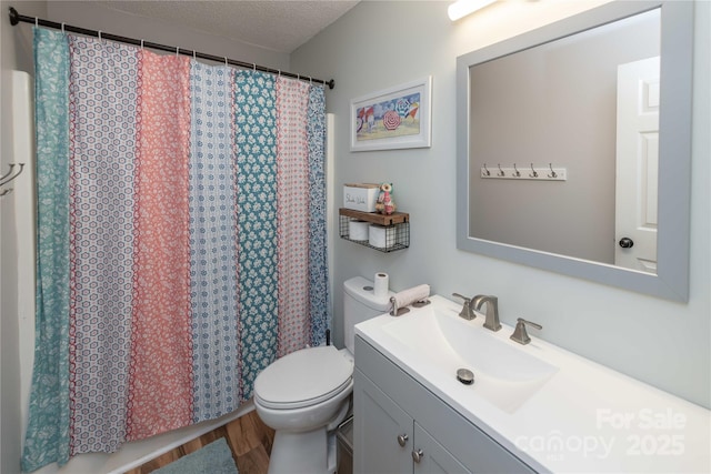 2085 Chapel Creek Rd SW, Concord, NC 28025 - bathroom featuring vanity, wood finished floors, a textured ceiling, and a shower with shower curtain