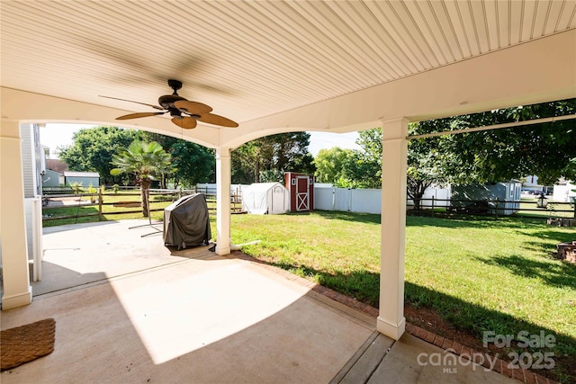 2085 Chapel Creek Rd SW, Concord, NC 28025 - fenced backyard with a patio, ceiling fan, a shed, and grilling area