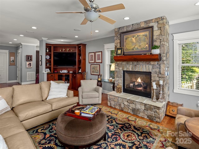 30 Stills Creek Loop, Fairview, NC 28730 - living area featuring a stone fireplace, wood finished floors, ornamental molding, ceiling fan, and recessed lighting
