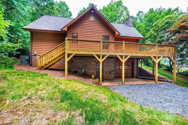 366 Charlois St, Hudson, NC 28638 - view of front of house featuring a deck, driveway, a front lawn, a chimney, and a shingled roof