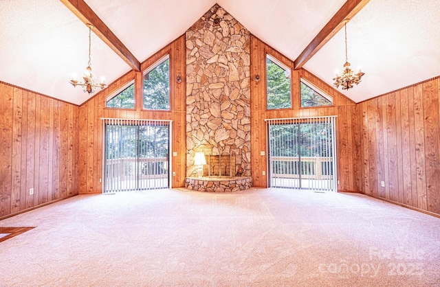 366 Charlois St, Hudson, NC 28638 - unfurnished living room featuring a chandelier, high vaulted ceiling, wood walls, and carpet