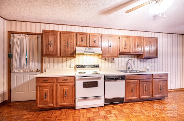 366 Charlois St, Hudson, NC 28638 - kitchen with white appliances, under cabinet range hood, wallpapered walls, light countertops, and brown cabinets