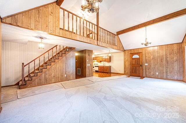 366 Charlois St, Hudson, NC 28638 - unfurnished living room featuring a chandelier, stairs, carpet floors, wooden walls, and beamed ceiling