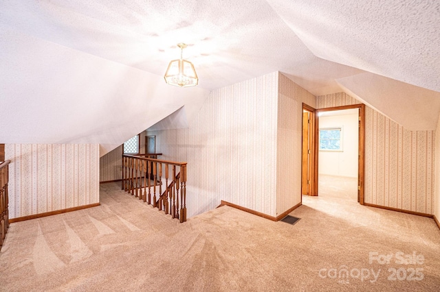 366 Charlois St, Hudson, NC 28638 - bonus room featuring wallpapered walls, carpet flooring, vaulted ceiling, and a chandelier