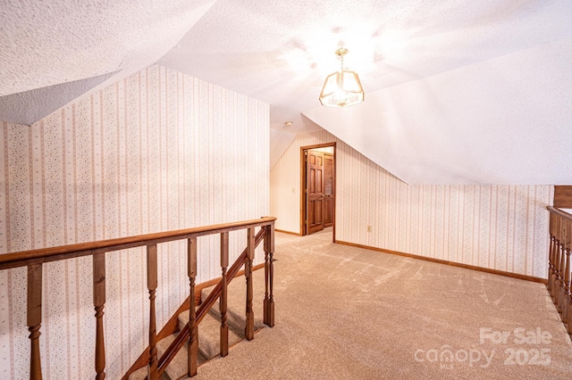 366 Charlois St, Hudson, NC 28638 - additional living space with vaulted ceiling, carpet flooring, wallpapered walls, and a textured ceiling