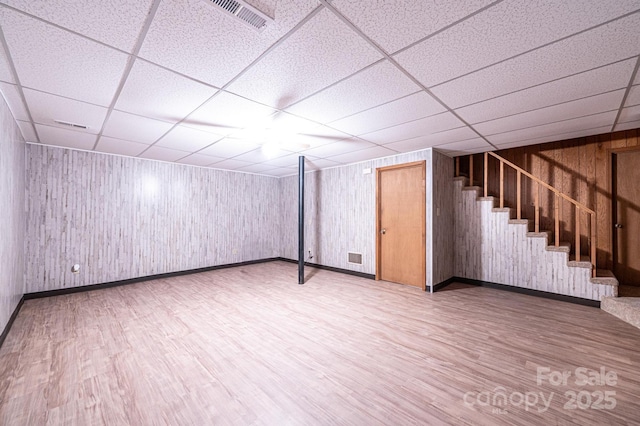 366 Charlois St, Hudson, NC 28638 - finished basement with wood finished floors, a paneled ceiling, stairway, and wooden walls