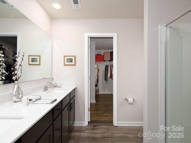 2796 Legacy Ridge Ln, Catawba, NC 28609 - bathroom with a spacious closet, double vanity, and wood finished floors
