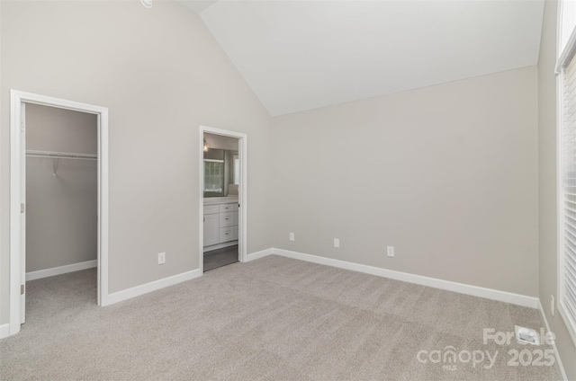 608 Red Hawk Way, Clover, SC 29710 - unfurnished bedroom featuring a walk in closet, light colored carpet, high vaulted ceiling, and connected bathroom