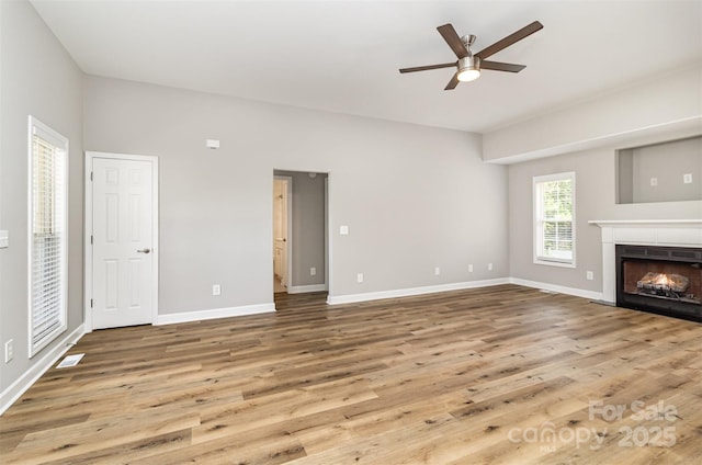 608 Red Hawk Way, Clover, SC 29710 - unfurnished living room featuring wood finished floors, ceiling fan, and a tiled fireplace