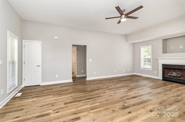 608 Red Hawk Way, Clover, SC 29710 - unfurnished living room featuring wood finished floors, ceiling fan, and a tiled fireplace