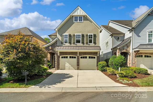 115 Boyce Rd, Charlotte, NC 28211 - view of front of property featuring concrete driveway, an attached garage, a standing seam roof, and stone siding