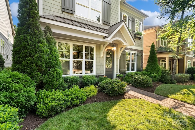 115 Boyce Rd, Charlotte, NC 28211 - property entrance featuring a standing seam roof, a metal roof, and a lawn