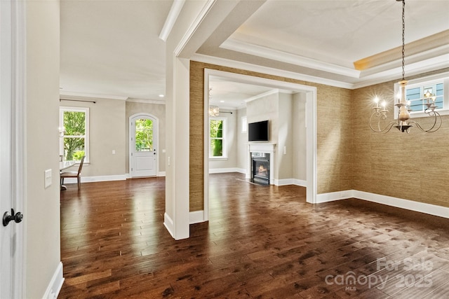 115 Boyce Rd, Charlotte, NC 28211 - unfurnished living room featuring a chandelier, wallpapered walls, ornamental molding, dark wood-style floors, and a premium fireplace