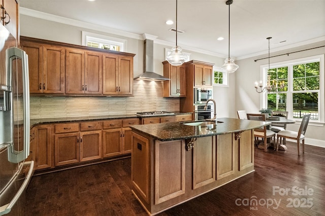 115 Boyce Rd, Charlotte, NC 28211 - kitchen featuring wall chimney range hood, brown cabinets, stainless steel appliances, an island with sink, and crown molding