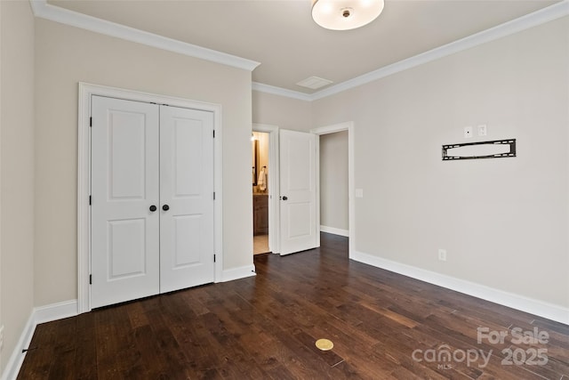 115 Boyce Rd, Charlotte, NC 28211 - unfurnished bedroom featuring ornamental molding, dark wood finished floors, and a closet