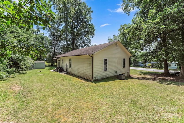 1631 Berkley St SW, Lenoir, NC 28645 - rear view of house featuring a lawn, a shed, and roof with shingles