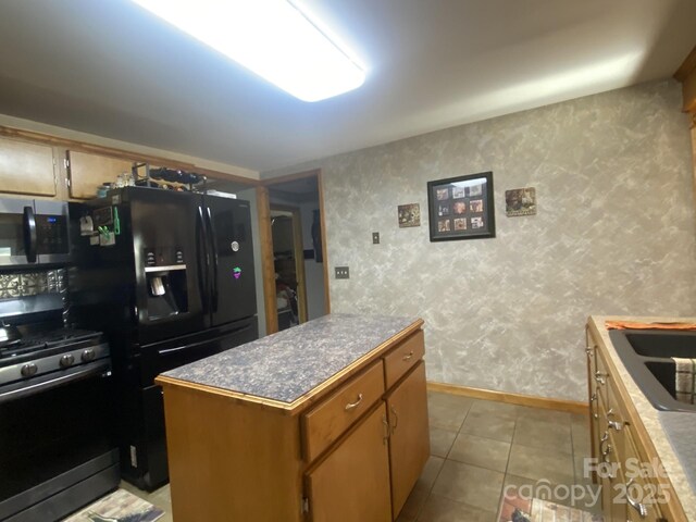 4303 Grier St, Gastonia, NC 28056 - kitchen featuring appliances with stainless steel finishes, a kitchen island, and tile patterned flooring